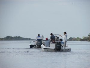 Boats head out into Louisiana's Barataria Bay.