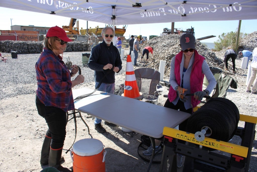 Steve Cochran, Campaign Director; Cathleen Berthelot, Campaign Manager; and Brooke Randolph, Office Manager cut and tie bags to be filled with shell.