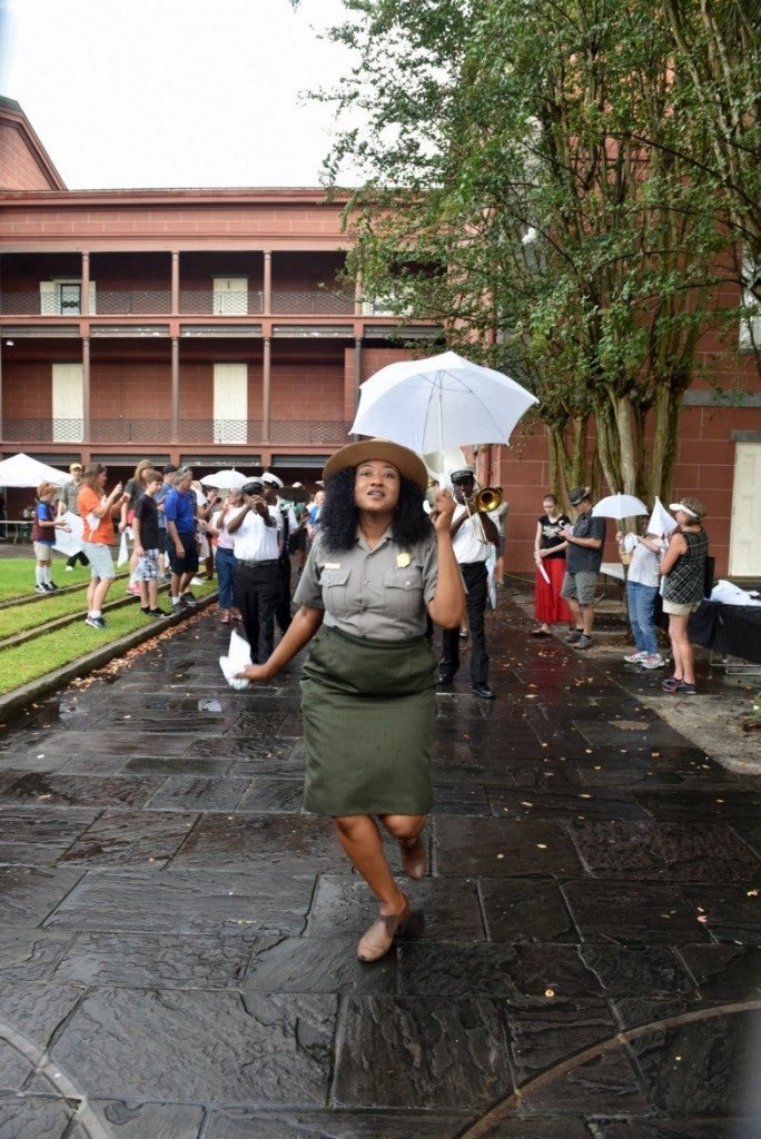 Chandra Teddleton leads the Second Line with Kinfolk Brass Band from the Old U.S. Mint to the Mississippi River (Photo courtesy of Kim Welsh)