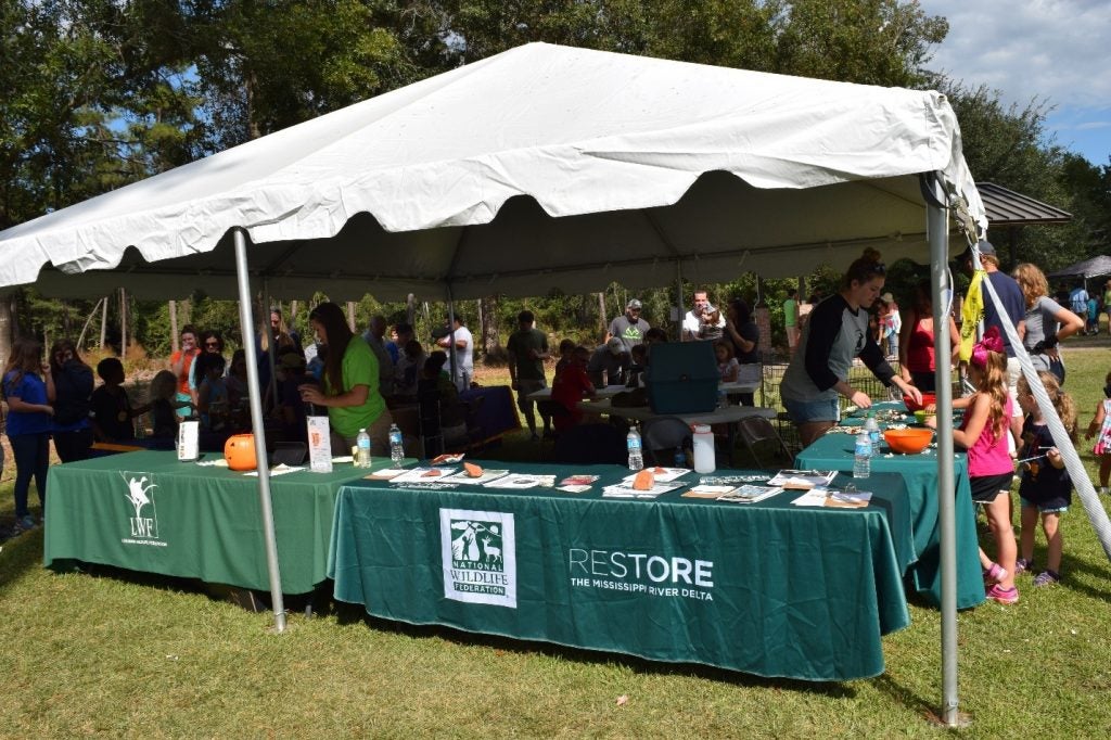 National Wildlife Federation and Louisiana Wildlife Federation tables and activities at the Bayou Lacombe Center during Wild Things. 